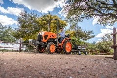 Kubota LX tractor working between vineyard rows
