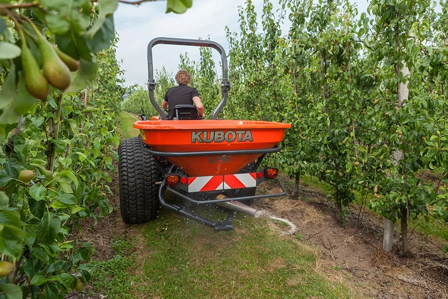 Kubota VS spreader working between orchard rows