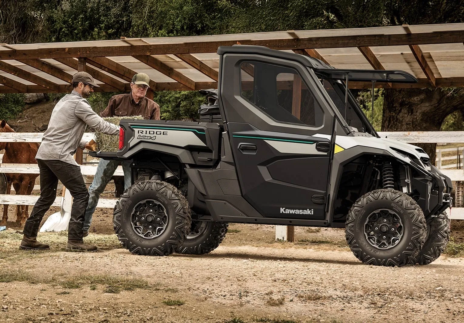 Kawasaki RIDGE three-passenger side-by-side hauling hay at a ranch