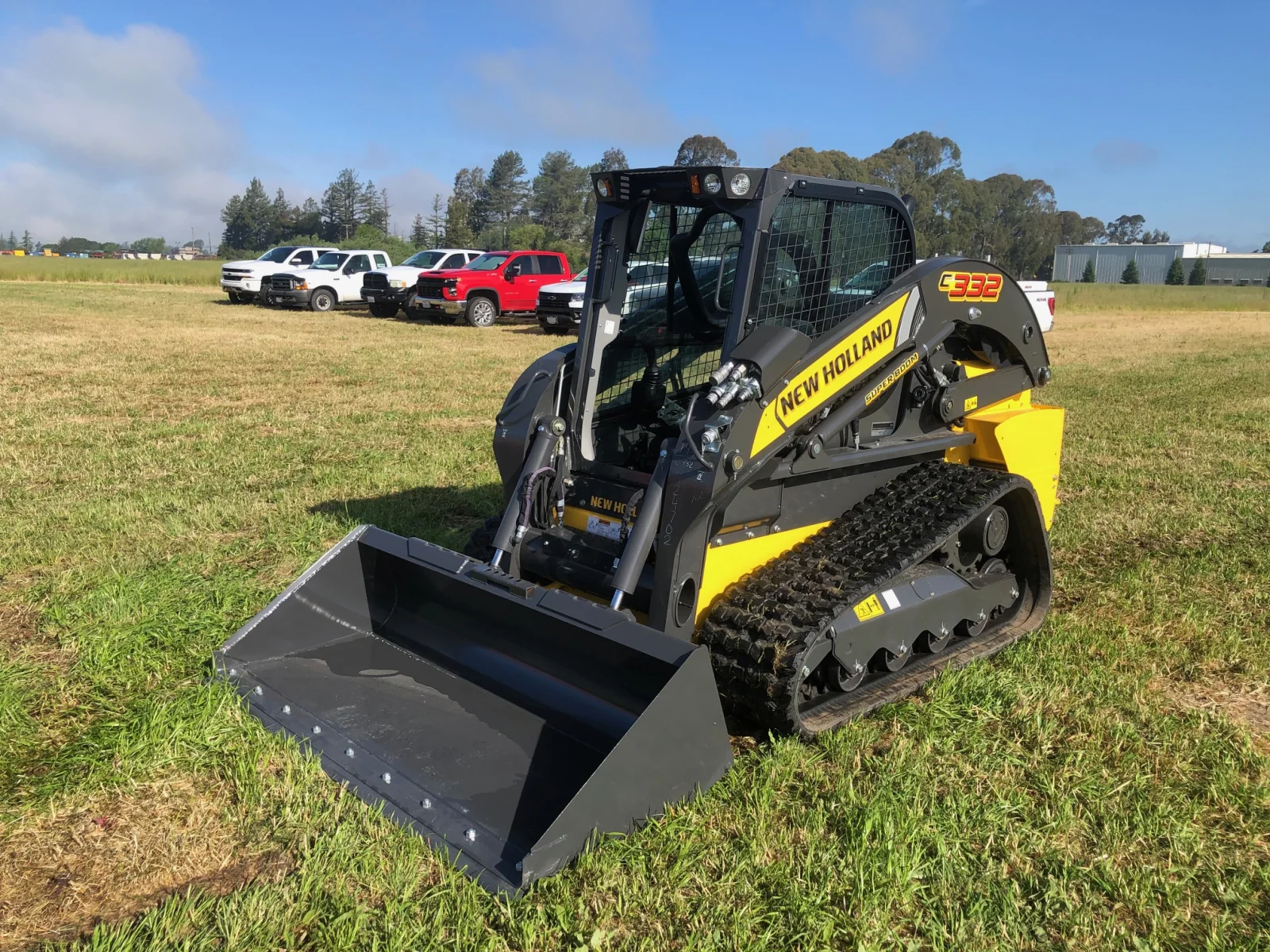 New Holland C332 compact track loader in a front three-quarter view with its bucket lowered