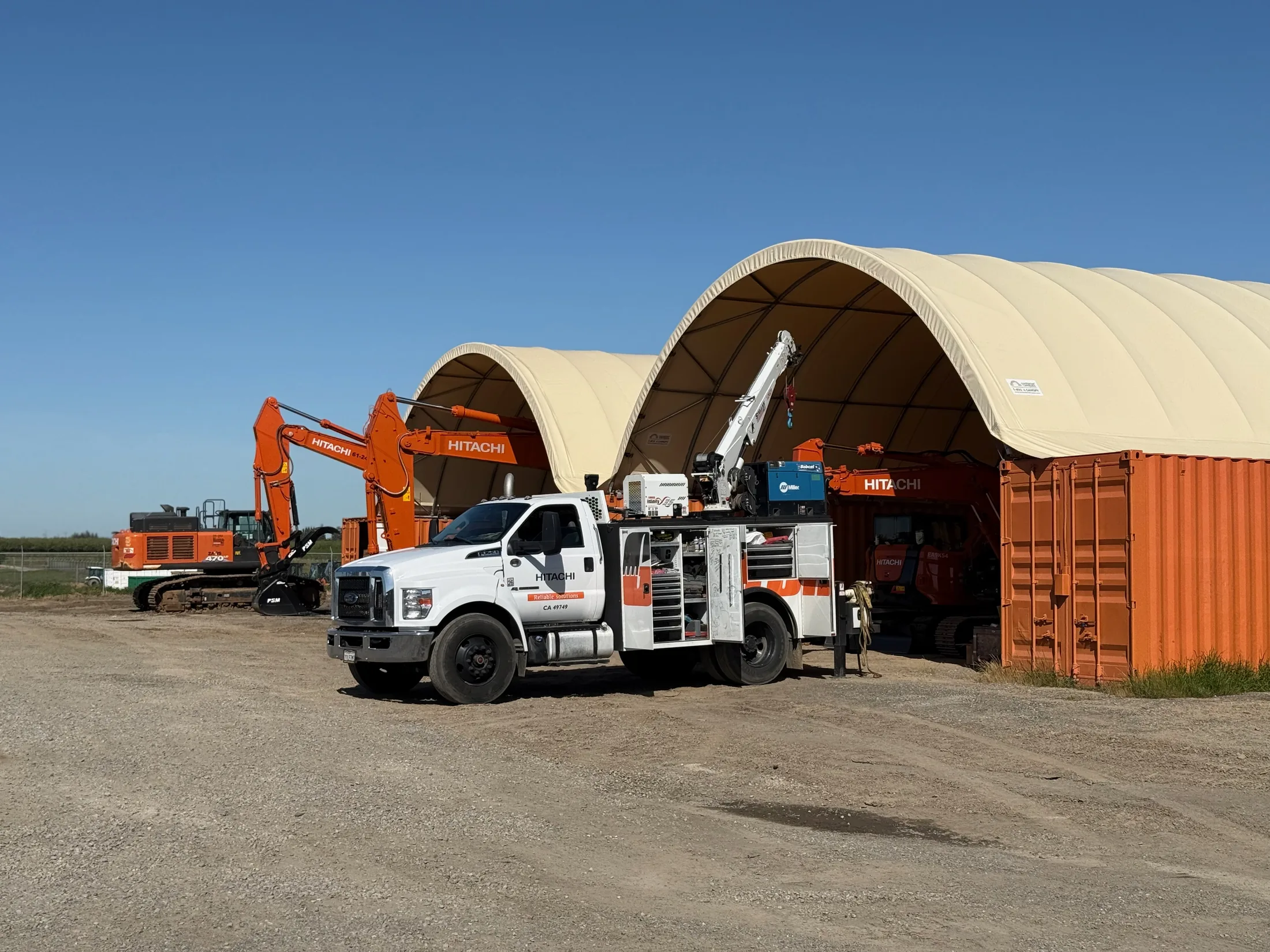 Garton construction equipment and service truck at a jobsite