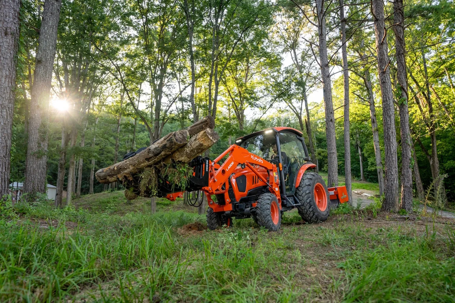 Kubota tractor with front loader working in a field